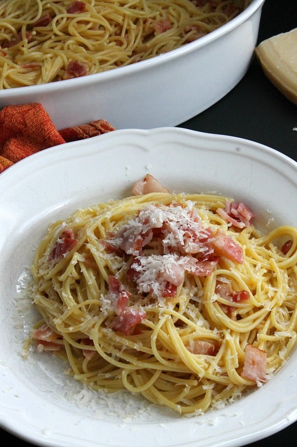 Bacon is the star of this Spaghetti alla Carbonara Recipe! A traditional Italian dish that is made simple and ready in 30 minutes! Spaghetti alla Carbonara in a white bowl
