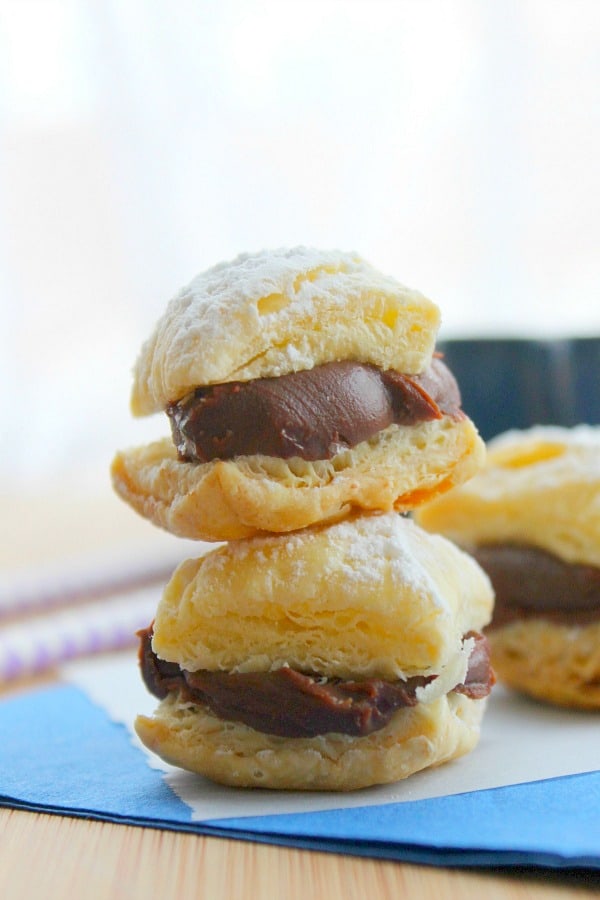 Four ingredient puff pastry dessert that brings alive these Miguelitos with Chocolate dessert! Perfect for Cinco de Mayo or any day of the week! Miguelitos with Chocolate stacked on blue napkint
