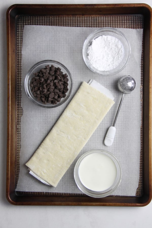 Four ingredient puff pastry dessert that brings alive these Miguelitos with Chocolate dessert! Perfect for Cinco de Mayo or any day of the week! Miguelitos with Chocolate Ingredients on baking sheet