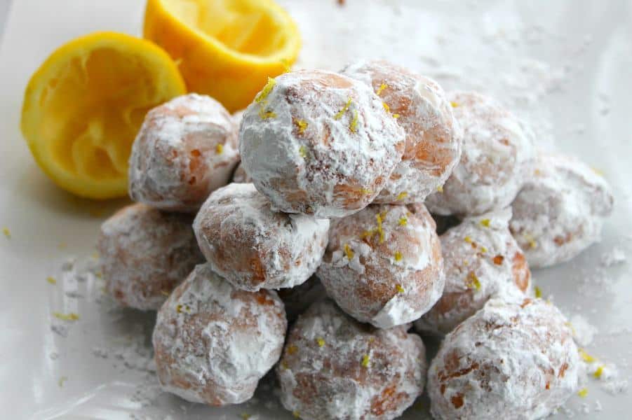 The best way to ring in Spring with with lots of citrus recipes including these Lemon Donut Holes! Lemon Donut Holes on white plate