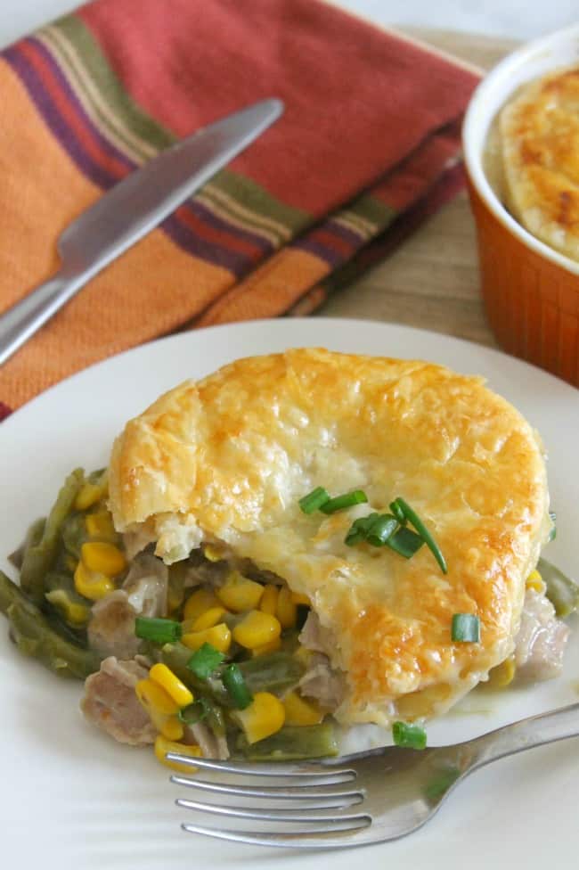 Leftover Turkey Puff Pastry Pot Pies is perfect for Thanksgiving leftovers. With turkey, green beans, corn, and other vegetables can be used! Leftover Turkey Puff Pastry Pot Pies on plate with fork.