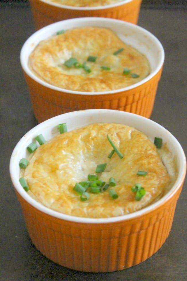 Leftover Turkey Puff Pastry Pot Pies is perfect for Thanksgiving leftovers. With turkey, green beans, corn, and other vegetables can be used! Leftover Turkey Puff Pastry Pot Pies in orange ramekins.
