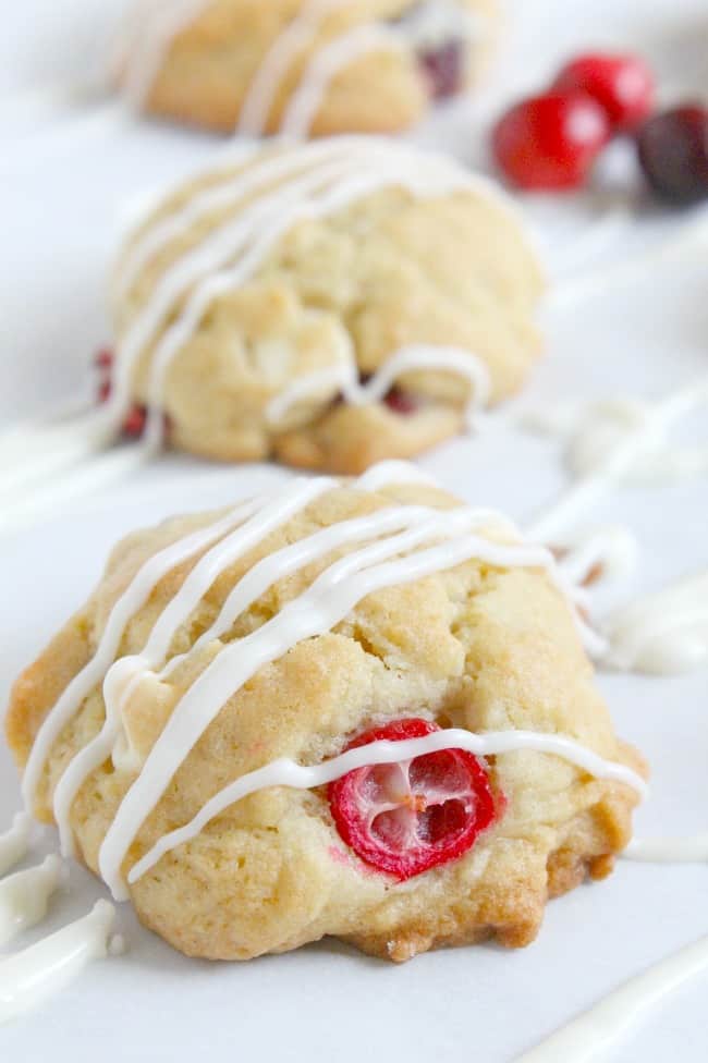 These Cranberry White Chocolate Chip Cookies will get you in the mood for baking! Loaded with lots of flavor, you won't want to pass them up! Cranberry White Chocolate Chip Cookies drizzled with chocolate.