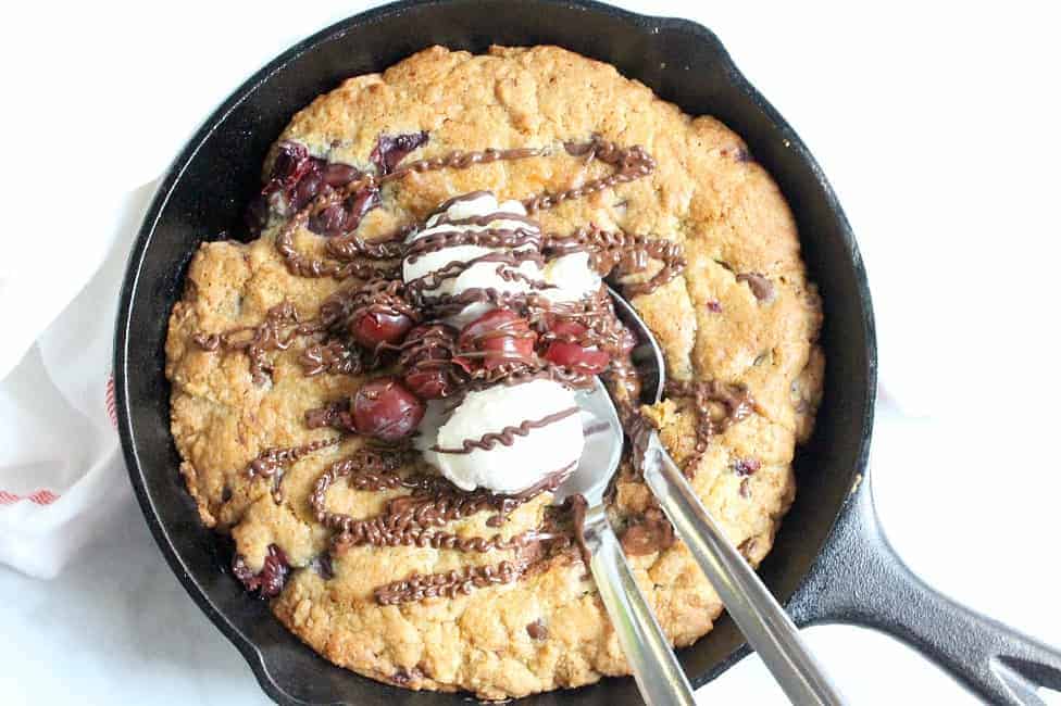 Warm chocolate chip cookie and cherries makes this delicious gooey Chocolate Cherry Skillet Cookie the perfect dessert for two! | The Bitter Side of Sweet #cookie #cherry #chocolate #dessert Chocolate Cherry Skillet Cookie in skillet