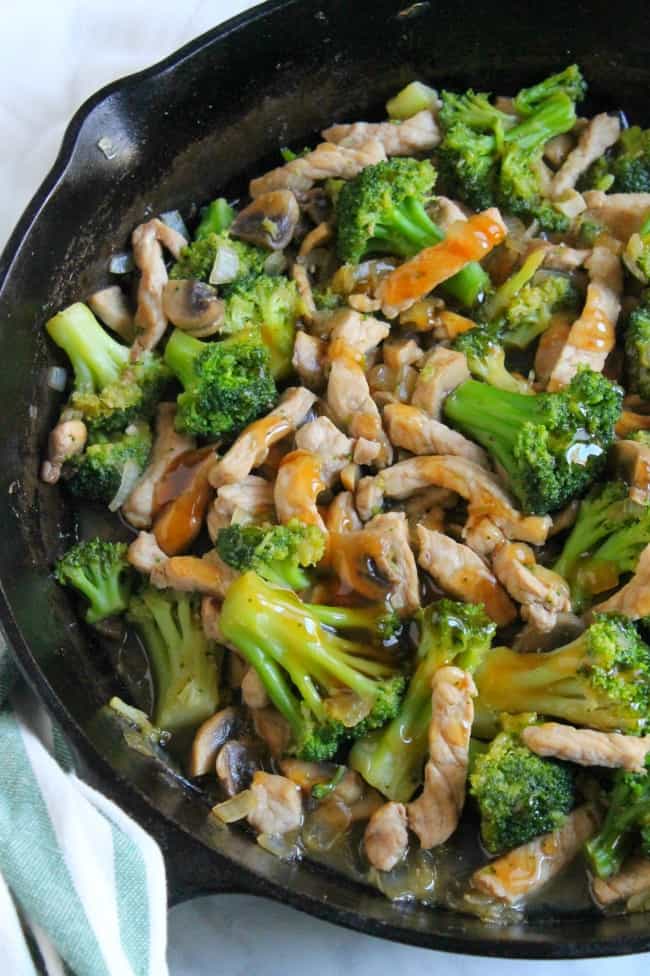 Broccoli Pork Stir Fry is a super quick meal to make! You can add it over rice and have dinner ready in less than 30 minutes! Broccoli Pork Stir Fry in black cast iron skillet