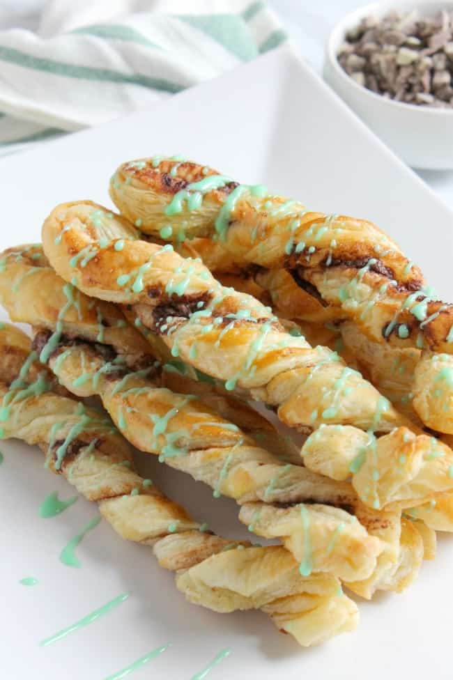 Mint Chocolate Cinnamon Sticks are an easy sweet treat. The chocolate mint combo in buttery puff pastry is the perfect combination! Mint Chocolate Cinnamon Sticks on white plate