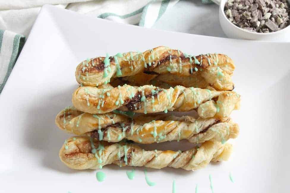 Mint Chocolate Cinnamon Sticks are an easy sweet treat. The chocolate mint combo in buttery puff pastry is the perfect combination! Mint Chocolate Cinnamon Sticks on white plate