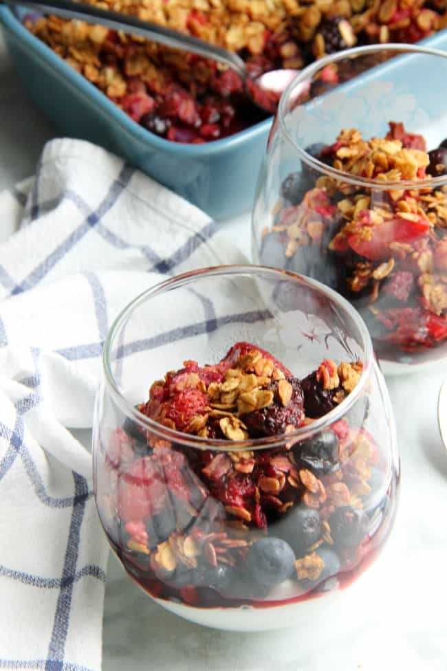 An easy baked dessert with a delicious crunchy topping! This Mixed Berry Crisp is a great way to use up those summer berries! Mixed Berry Crisp in glass cup