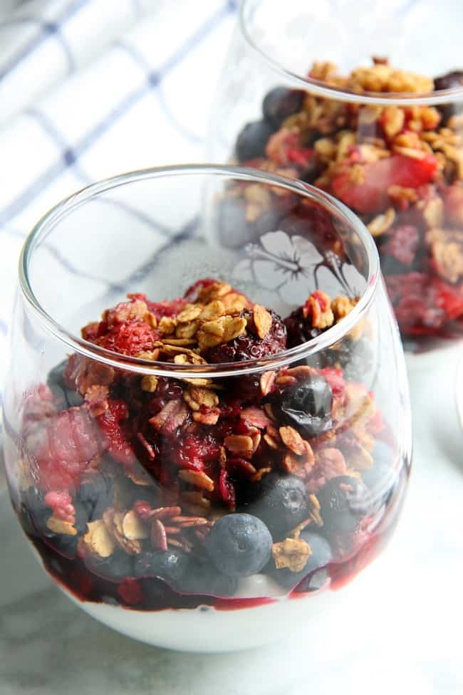 An easy baked dessert with a delicious crunchy topping! This Mixed Berry Crisp is a great way to use up those summer berries!| The Bitter Side of Sweet #berries #summerdesserts #oats Mixed Berry Crisp in glass cup