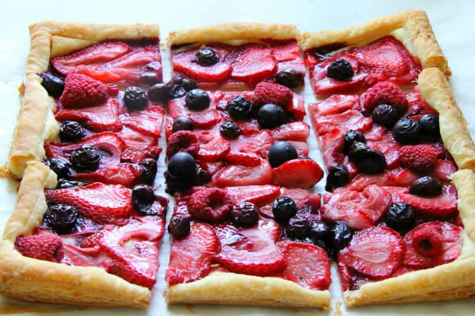 This easy Mixed Berry Tart makes for one spectacular summer dessert. It couldn’t be easier and easily adapted to any berry you wanted to use! Mixed Berry Tart on white background