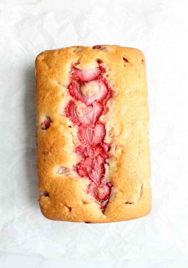 Take a classic pound cake and add summer strawberries to it to make a delicious moist cake! This Strawberry Sour Cream Pound cake will not disappoint! | The Bitter Side of Sweet Strawberry Sour Cream Pound Cake on a white background