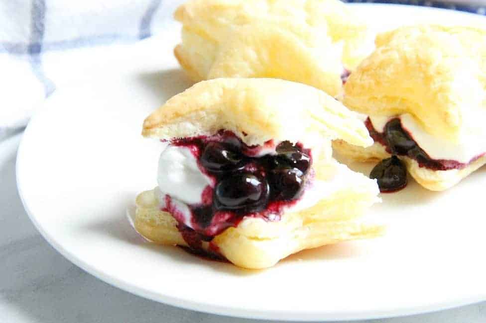 Blueberry Cream Puffs are an easy dessert for any summer barbecue you throw. Summer might be almost over, but these sweet treats are good all year long. | The Bitter Side of Sweet #blueberries #puffpastry Blueberry Cream Puffs