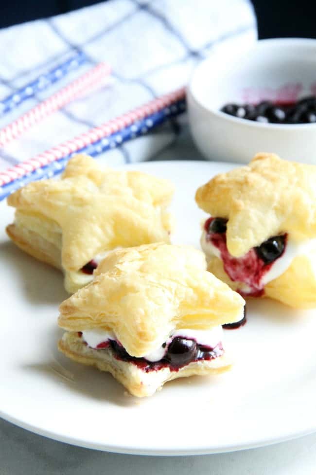 Blueberry Cream Puffs are an easy dessert for any summer barbecue you throw. Summer might be almost over, but these sweet treats are good all year long. | The Bitter Side of Sweet #blueberries #puffpastry Blueberry Cream Puffs