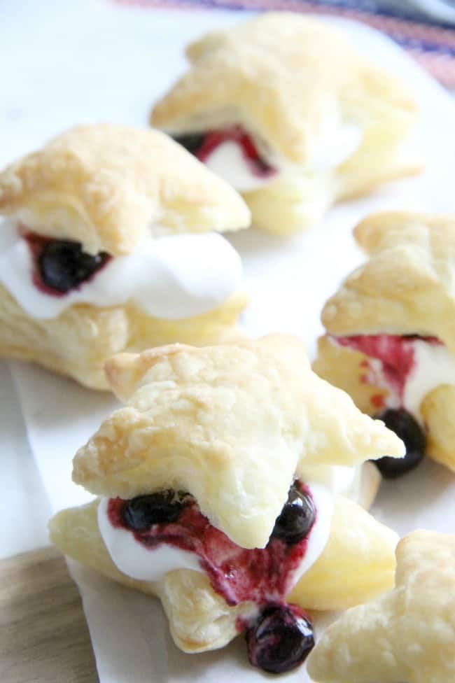 Blueberry Cream Puffs are an easy dessert for any summer barbecue you throw. Summer might be almost over, but these sweet treats are good all year long. | The Bitter Side of Sweet #blueberries #puffpastry Blueberry Cream Puffs
