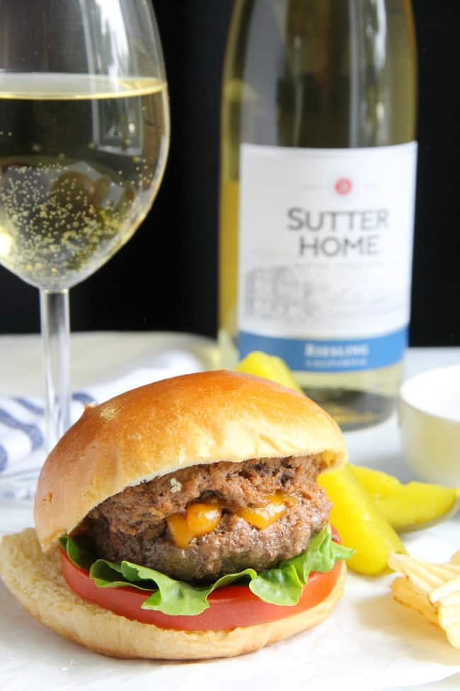 This Spicy Sriracha Juicy Lucy is a classic burger with a spicy twist! Found in Minnesota this burger pairs well with a glass of Sutter Home Riesling! | The Bitter Side of Sweet #SweetonSpice #ad Spicy Sriracha Juicy Lucy