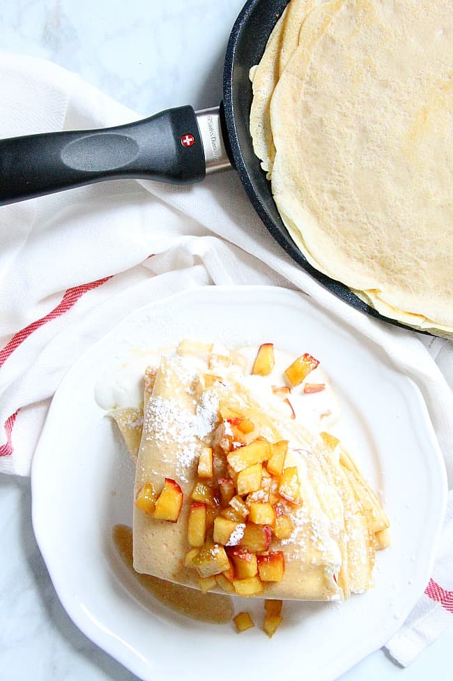 A popular French pastry these Apple Pie Crepes are elegant yet satisfying! They are filled with a warm apple compote and freshly made whipped cream! | The Bitter Side of Sweet #apples #breakfast #dessert Apple Pie Crepes