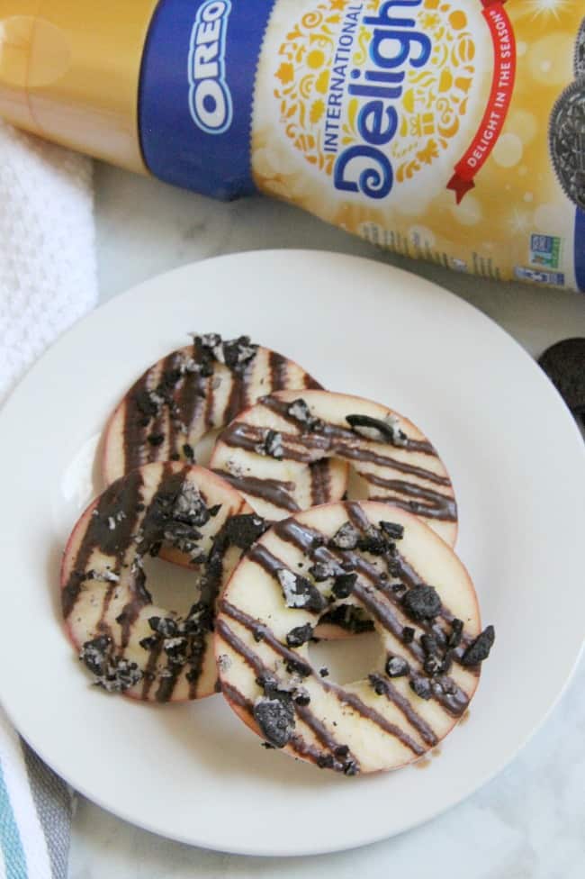 Indulging in this back to school treat for kids by adding fruit and dark chocolate to these Chocolate Oreo Apple Donuts! Your kids will be jumping for joy! | The Bitter Side of Sweet #SnackTimeDelight #ad #oreo #chocolate #apples Chocolate Oreo Apple Donuts with product