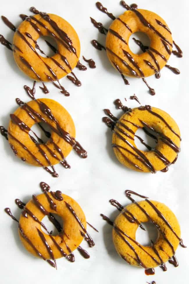 These Pumpkin Chocolate Donuts will not disappoint. They are a soft baked donut that has chocolate throughout. This makes the perfect fall treat! | The Bitter Side of Sweet #pumpkinweek #sponsored #pumpkin #donuts #breakfast Pumpkin Chocolate Donuts