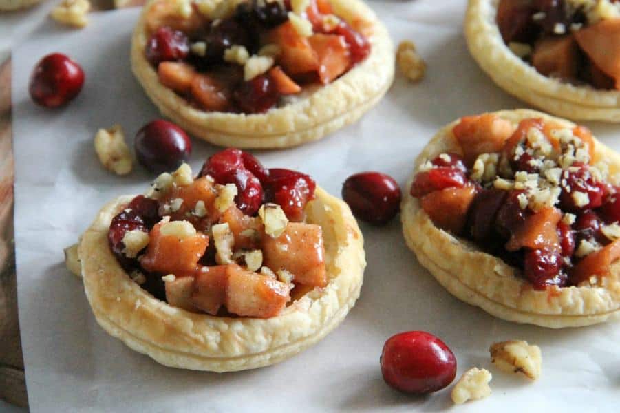 These Cranberry Apple Walnut Tarts would be the perfect addition to your holiday dessert table! Perfect for when you want to make individual desserts! | The Bitter Side of Sweet #cranberry #walnut #puffpastry #apple Cranberry Apple Walnut Tarts with cranberries