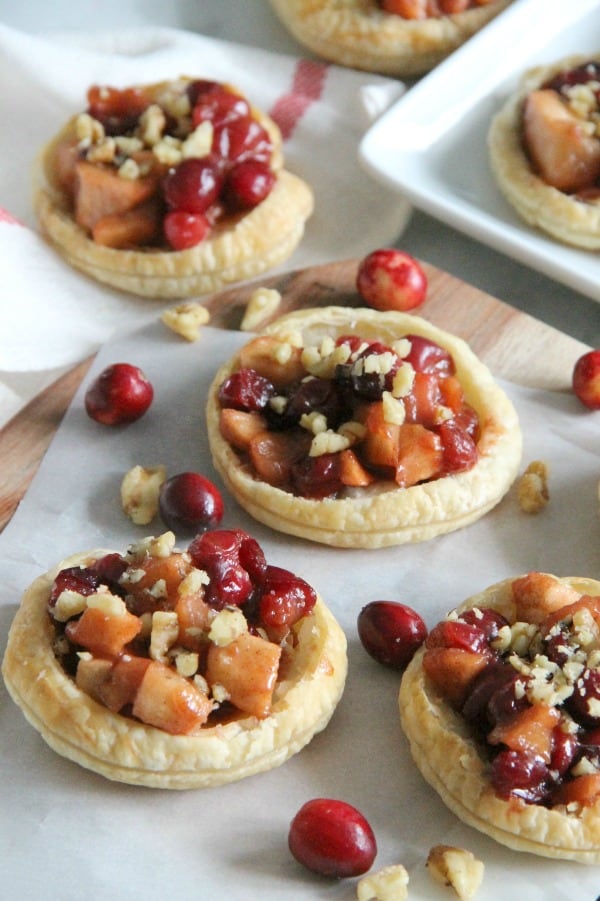 These Cranberry Apple Walnut Tarts would be the perfect addition to your holiday dessert table! Perfect for when you want to make individual desserts! | The Bitter Side of Sweet #cranberry #walnut #puffpastry #apple Cranberry Apple Walnut Tarts with white towl