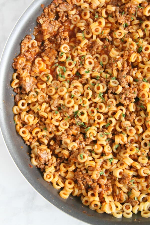 Easy Homemade Spaghetti O's are a family favorite! Made with tomato sauce, spices and ground beef. Fun large ring pasta noodles completes this meal! | The Bitter Side of Sweet #farmtocan #pasta #groundbeef #30minutemeals Homemade Spaghetti O's in skillet