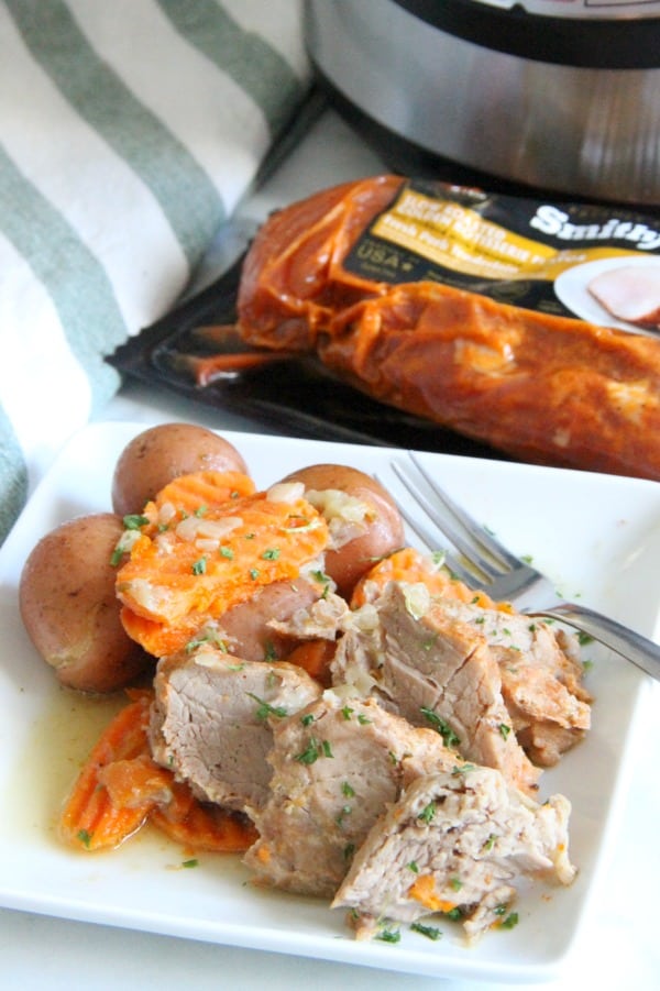 Instant Pot Pork Tenderloin with Potatoes & Carrots is so much easier to make then you think! Cooks in less than 30 minutes! Instant Pot Pork with Potatoes and Carrots on white plate