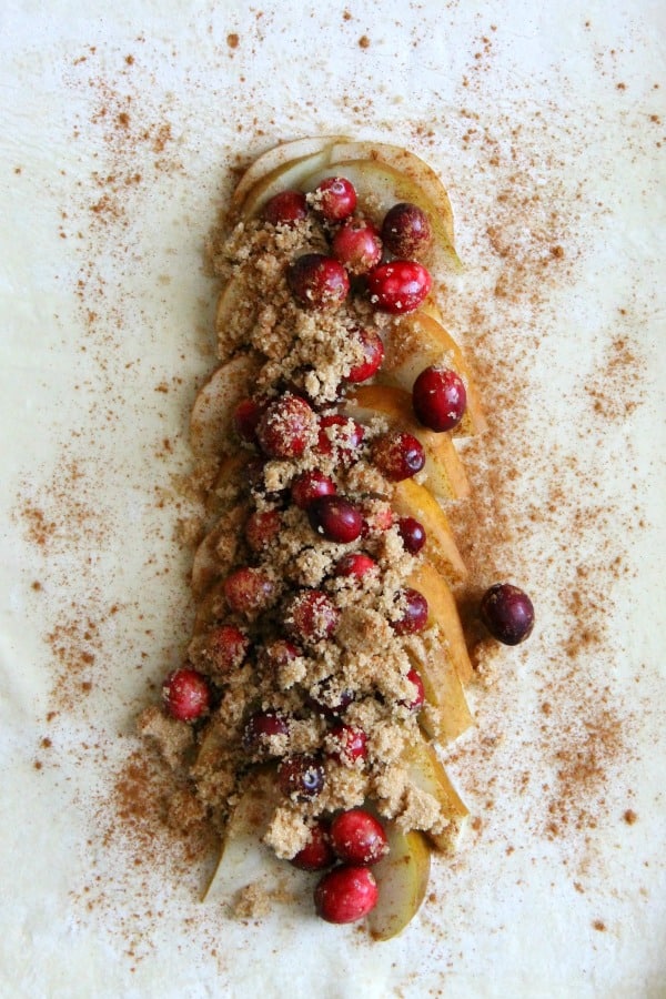 Cranberry Pear Strudel is a simple, sweet dessert! A few ingredients of seasonal fruit and puff pastry and you have the perfect treat! | The Bitter Side of Sweet #puffpastry #cranberry #pear Cranberry Pear Strudel on white background