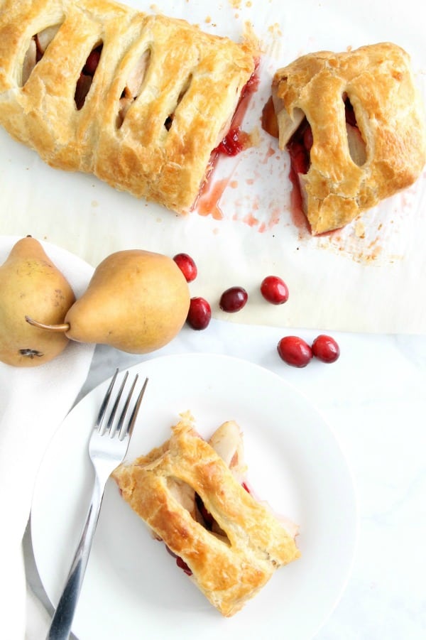 Cranberry Pear Strudel is a simple, sweet dessert! A few ingredients of seasonal fruit and puff pastry and you have the perfect treat! | The Bitter Side of Sweet #puffpastry #cranberry #pear Cranberry Pear Strudel on white plate