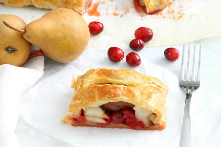 Cranberry Pear Strudel is a simple, sweet dessert! A few ingredients of seasonal fruit and puff pastry and you have the perfect treat! | The Bitter Side of Sweet #puffpastry #cranberry #pear Cranberry Pear Strudel on white plate