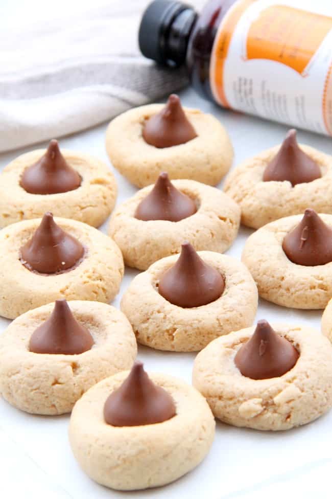 Cookie Butter Blossom Cookies are an easy to make cookie that bakes up in 10 minutes! These blossom cookies are a twist to the classic cookie! | #christmassweetsweek #ad | The Bitter Side of Sweet #cookiebutter Cookie Butter Blossom Cookies on white plate