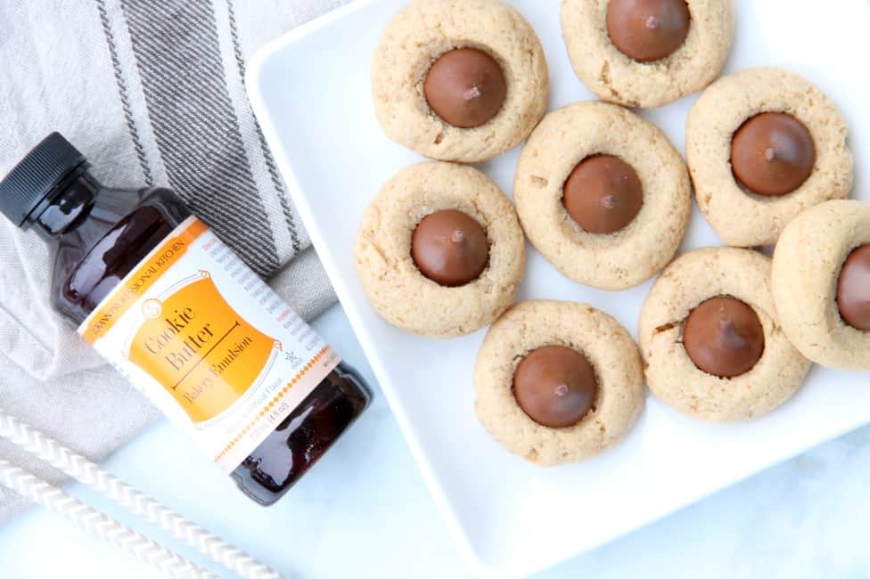 Cookie Butter Blossom Cookies are an easy to make cookie that bakes up in 10 minutes! These blossom cookies are a twist to the classic cookie! | #christmassweetsweek #ad | The Bitter Side of Sweet #cookiebutter Cookie Butter Blossom Cookies on white plate