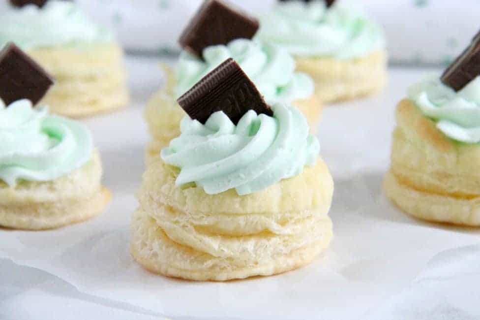 Mint Chocolate Puff Pastry Tartlets are the perfect individual dessert for entertaining! The flavors of mint and chocolate pair well with a whipped cream frosting, to make this out of this world! Mint Chocolate Puff Pastry Tartlets on white background