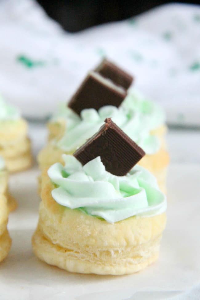 Mint Chocolate Puff Pastry Tartlets are the perfect individual dessert for entertaining! The flavors of mint and chocolate pair well with a whipped cream frosting, to make this out of this world! Mint Chocolate Puff Pastry Tartlets on white background