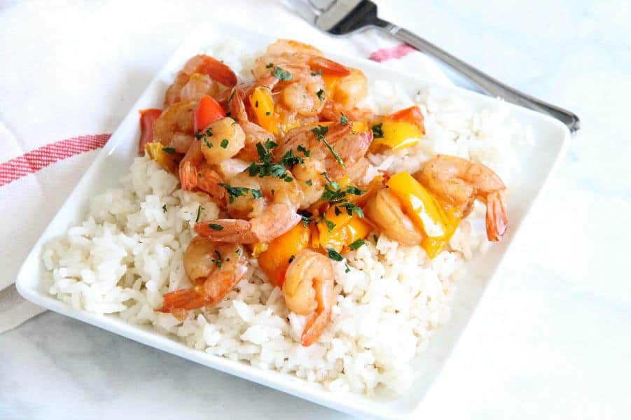 This Instant Pot Sweet and Sour Shrimp is one of the easiest dishes to make! Total cook time 8 minutes which makes this a perfect weeknight meal! Instant Pot Sweet and Sour Shrimp on white plate