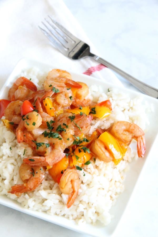 This Instant Pot Sweet and Sour Shrimp is one of the easiest dishes to make! Total cook time 8 minutes which makes this a perfect weeknight meal! Instant Pot Sweet and Sour Shrimp on white plate