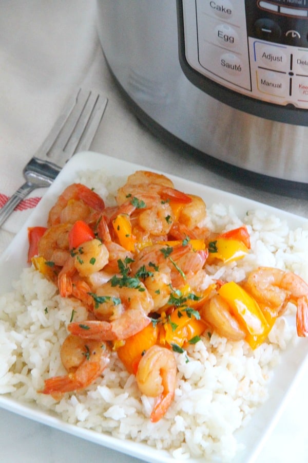 This Instant Pot Sweet and Sour Shrimp is one of the easiest dishes to make! Total cook time 8 minutes which makes this a perfect weeknight meal! Instant Pot Sweet and Sour Shrimp on white plate