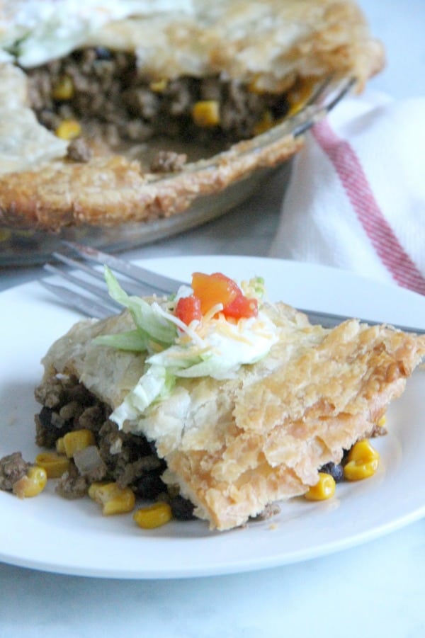 Puff Pastry Taco Pot Pie makes getting dinner on the table a total snap. Bonus points: it totally works for Taco Tuesday AND One Dish Wednesday. | The Bitter Side of Sweet #tacotuesday #easydinner #puffpastry Puff Pastry Taco Pot Pie on white plate