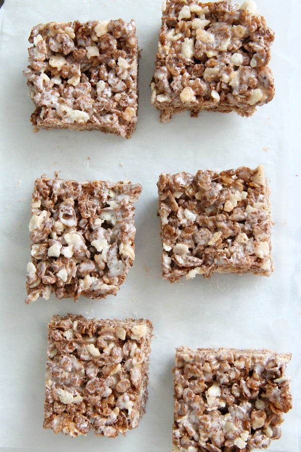 Cocoa Marshmallow Treats are a fun twist to traditional cereal treats! I've added in some chocolate cereal to take these to the next level! Cocoa Marshmallow Treats on white paper