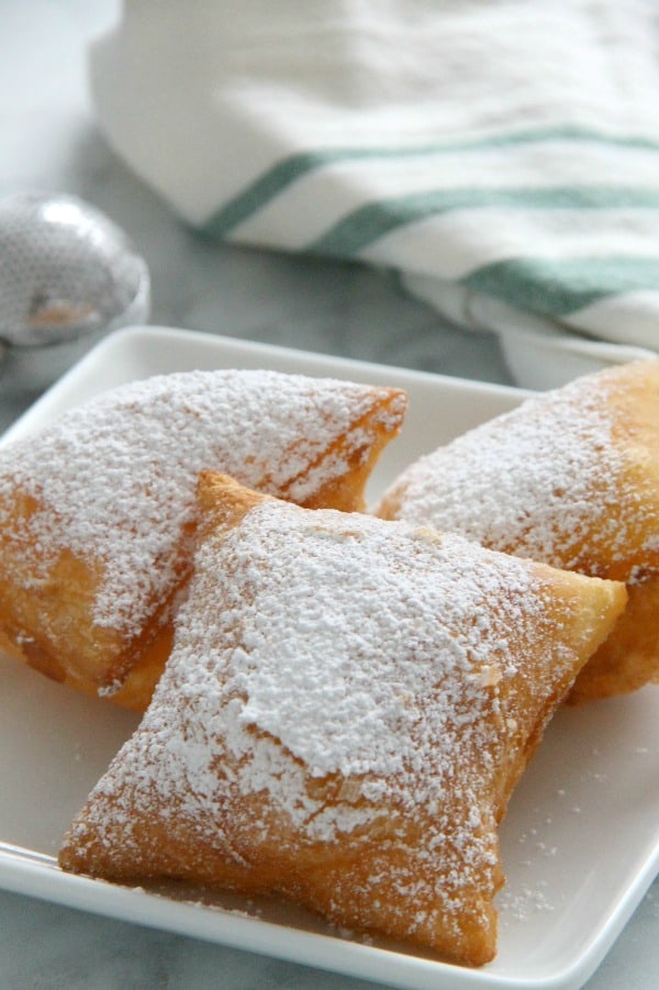 Puff Pastry Beignets are here for you when you're ready to let the good times roll. They don't have to just be for Fat Tuesday! Puff Pastry Beignets on white plate