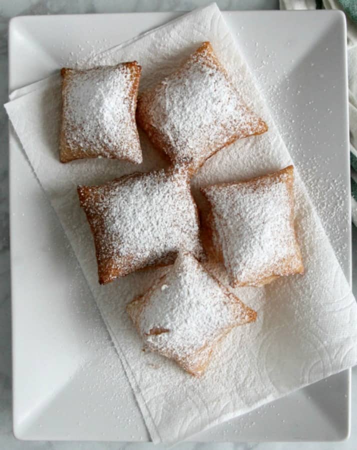 Puff Pastry Beignets are here for you when you're ready to let the good times roll. They don't have to just be for Fat Tuesday! Puff Pastry Beignets on white plate