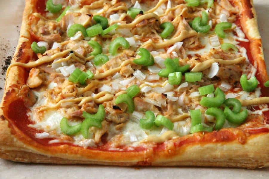 Puff Pastry Honey Mustard Chicken Pizza is made easy with the help of a rotisserie chicken and a little honey mustard sauce. Dinner is done, y'all! Puff Pastry Honey Mustard Chicken Pizza on parchment paper