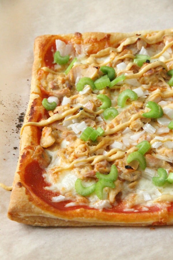 Puff Pastry Honey Mustard Chicken Pizza is made easy with the help of a rotisserie chicken and a little honey mustard sauce. Dinner is done, y'all! Puff Pastry Honey Mustard Chicken Pizza on parchment paper