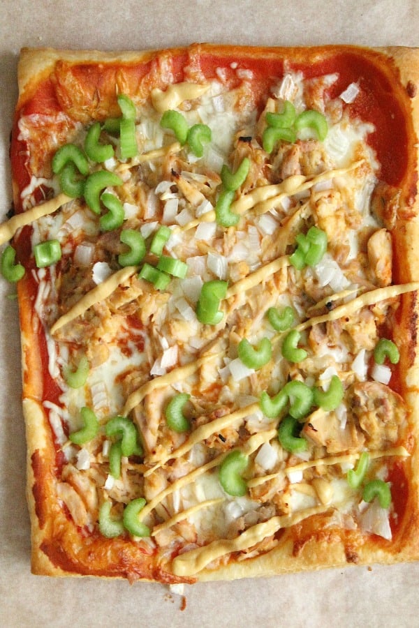 Puff Pastry Honey Mustard Chicken Pizza is made easy with the help of a rotisserie chicken and a little honey mustard sauce. Dinner is done, y'all! Puff Pastry Honey Mustard Chicken Pizza on parchment paper