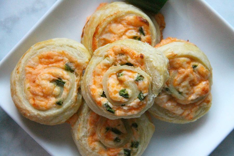 Puff Pastry Jalapeño Popper Pinwheels are just as ready for a game day as you are! They transport perfectly for tailgates. Puff Pastry Jalapeno Popper Pinwheels on white plate