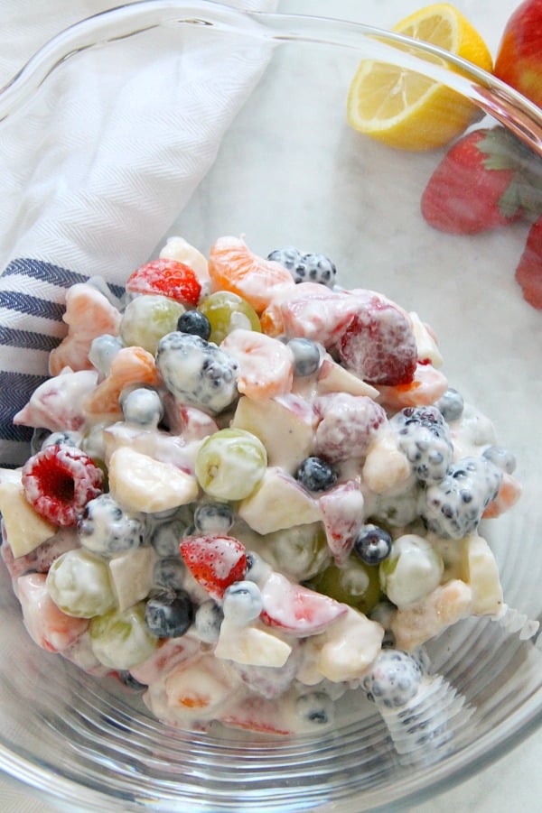 Creamy Yogurt Fruit Salad is a delicious alternative to a sweet dessert! Packed with lots of fruit, greek yogurt and honey, this salad will not disappoint! Creamy Yogurt Fruit Salad in glass bowl
