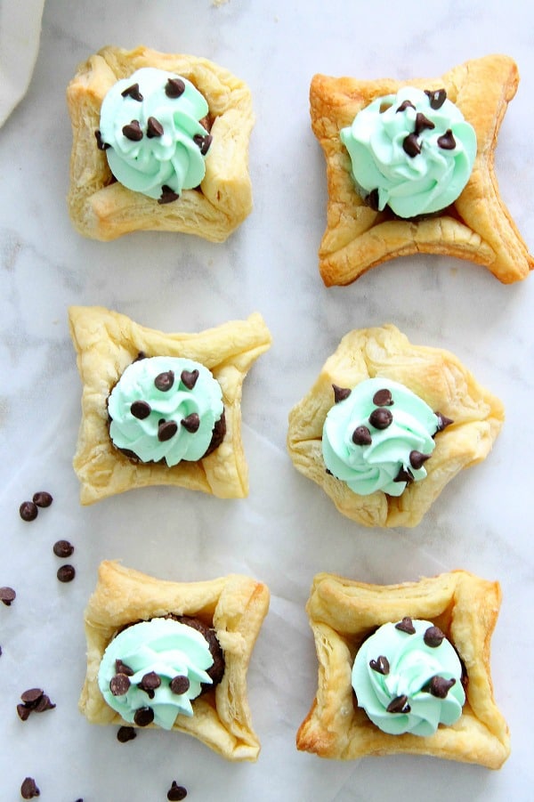 These Mint Chocolate Brownie Cups are a sweet addition to your next dinner party. Puff Pastry always adds a little bit of elegance to any dessert! Mint Chocolate Brownie Cups on white background