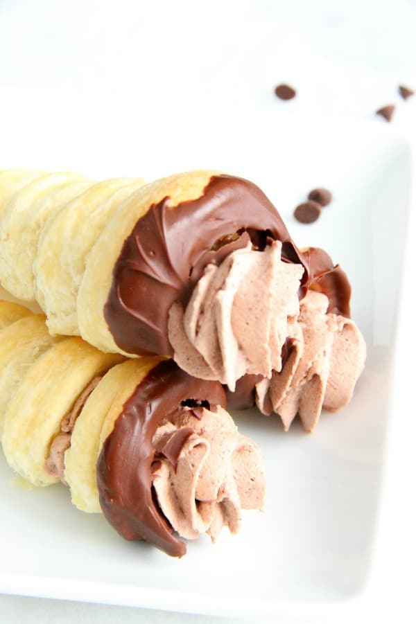 Chocolate Cream Horns are a sweet, delicate dessert for the chocolate lover in your life. You will love how easy they are! | The Bitter Side of Sweet Chocolate Cream Horns on white plate