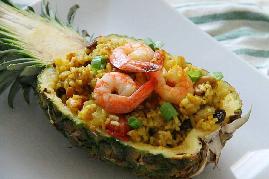 This Pineapple Fried Rice is the best combination of sweet and savory! Seasoned with curry and fruit this fried rice will not disappoint! Pineapple Fried Rice in pineapple shell