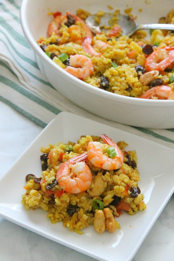 This Pineapple Fried Rice is the best combination of sweet and savory! Seasoned with curry and fruit this fried rice will not disappoint! Pineapple Fried Rice on white plate