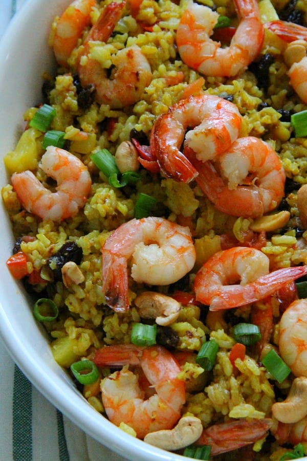 This Pineapple Fried Rice is the best combination of sweet and savory! Seasoned with curry and fruit this fried rice will not disappoint! Pineapple Fried Rice in white bowl